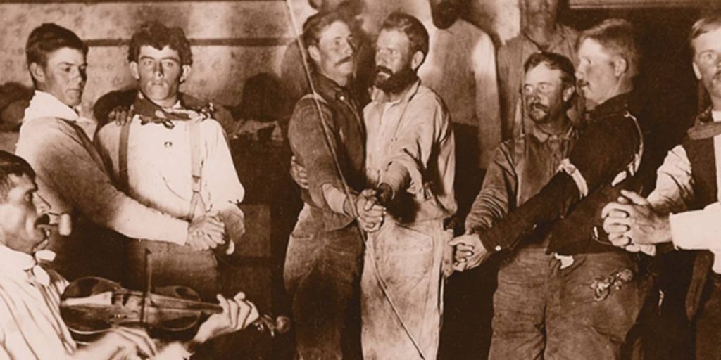 A photograph of an all-men’s Cowboy Stag Dance at a work camp, c. 1910. Photographer Unknown,True West Magazine